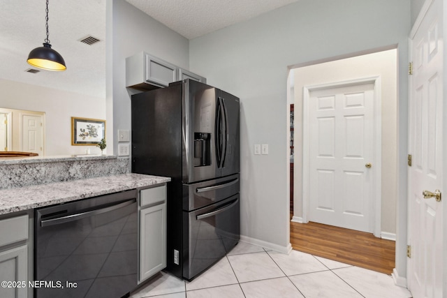 96031 Glen Laurel Ct, Yulee, FL 32097 - kitchen featuring dishwashing machine, fridge with ice dispenser, light stone countertops, decorative light fixtures, and light tile patterned floors
