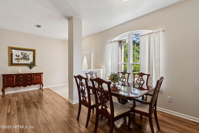 96031 Glen Laurel Ct, Yulee, FL 32097 - dining space featuring wood finished floors and a textured ceiling