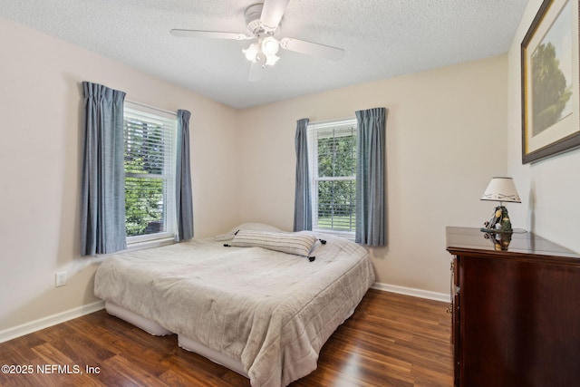 96031 Glen Laurel Ct, Yulee, FL 32097 - bedroom featuring dark wood finished floors, a textured ceiling, and a ceiling fan