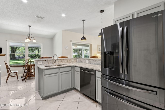 96031 Glen Laurel Ct, Yulee, FL 32097 - kitchen with fridge with ice dispenser, dishwashing machine, a peninsula, healthy amount of natural light, and a textured ceiling
