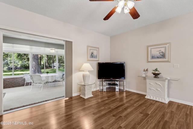 96031 Glen Laurel Ct, Yulee, FL 32097 - living area featuring wood finished floors, a ceiling fan, and a textured ceiling