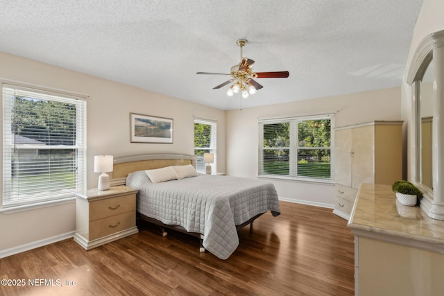 96031 Glen Laurel Ct, Yulee, FL 32097 - bedroom featuring dark wood-type flooring, a textured ceiling, and ceiling fan