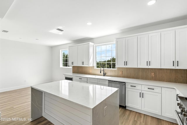 82 Cortez Ave, Saint Augustine, FL 32080 - kitchen with dishwasher, light wood-style flooring, a center island, recessed lighting, and stove