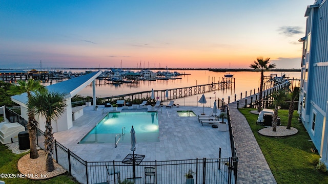 82 Cortez Ave, Saint Augustine, FL 32080 - pool at dusk featuring a water view, a patio, and a community pool