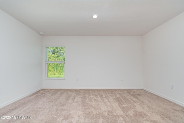 12 Wood Amber Ln, Palm Coast, FL 32164 - spare room with light carpet, recessed lighting, and a smoke detector