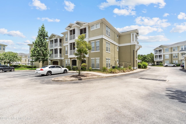 8290 Gate Pkwy Unit 1115, Jacksonville, FL 32216 - view of building exterior with uncovered parking