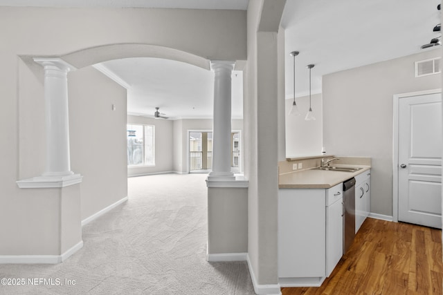 8290 Gate Pkwy Unit 1115, Jacksonville, FL 32216 - kitchen with decorative columns, a ceiling fan, and light countertops