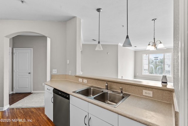 8290 Gate Pkwy Unit 1115, Jacksonville, FL 32216 - kitchen with dishwasher, arched walkways, dark wood-style flooring, white cabinetry, and hanging light fixtures