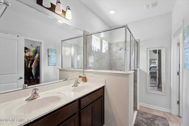 737 Windermere Way, Saint Augustine, FL 32095 - bathroom with a stall shower, double vanity, tile patterned floors, and a spacious closet