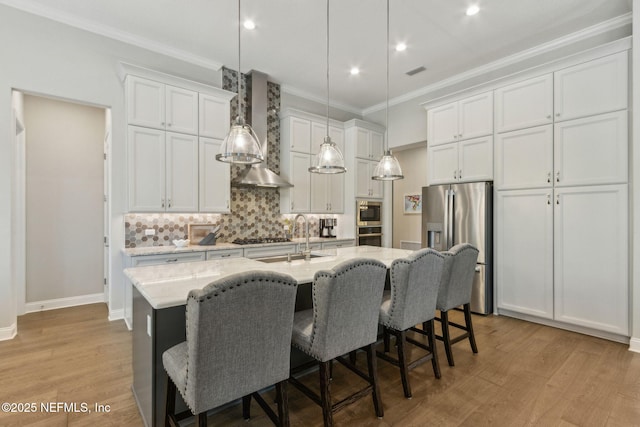 95049 Wild Cherry Dr, Fernandina Beach, FL 32034 - kitchen with appliances with stainless steel finishes, wall chimney exhaust hood, crown molding, decorative backsplash, and white cabinets