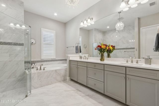 95049 Wild Cherry Dr, Fernandina Beach, FL 32034 - full bathroom featuring a chandelier, double vanity, a bath, and a shower stall