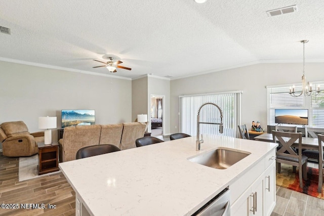 4032 Sandbank Ct, Middleburg, FL 32068 - kitchen with light wood finished floors, light stone countertops, a chandelier, ceiling fan, and white cabinetry