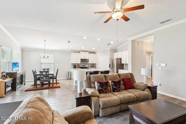 4032 Sandbank Ct, Middleburg, FL 32068 - living area featuring a textured ceiling, a ceiling fan, a chandelier, ornamental molding, and recessed lighting