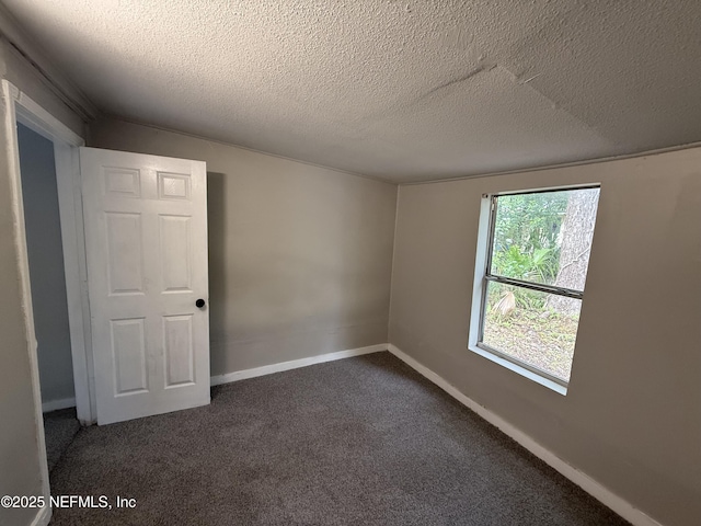 925 W 25th St, Jacksonville, FL 32209 - empty room featuring a textured ceiling and dark carpet