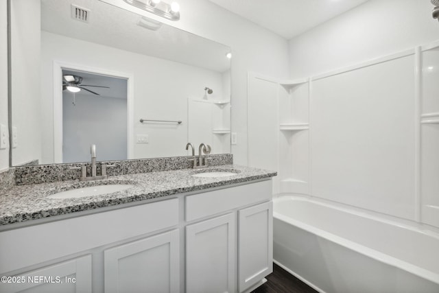 2350 Jayson Ave, Jacksonville, FL 32208 - bathroom featuring double vanity, shower / washtub combination, a ceiling fan, and wood finished floors