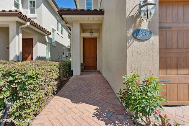 1387 Sunset View Ln, Jacksonville, FL 32207 - doorway to property with stucco siding and a tiled roof