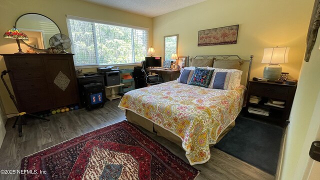 2708 SW 14th Dr Unit 220, Gainesville, FL 32608 - bedroom with wood finished floors and a textured ceiling