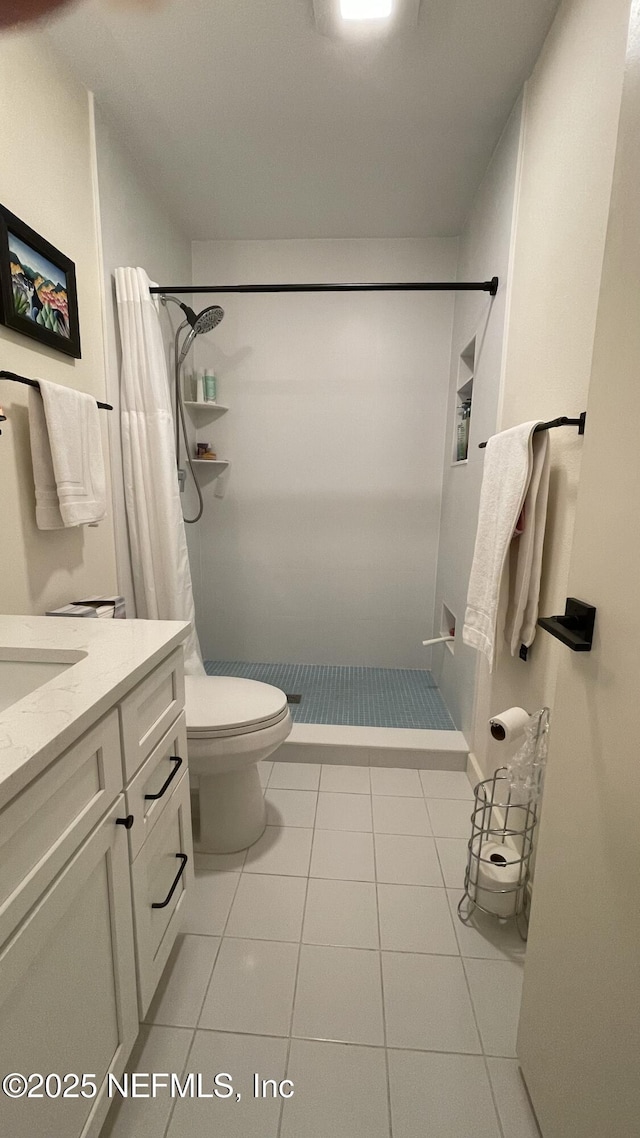 2708 SW 14th Dr Unit 220, Gainesville, FL 32608 - full bathroom with a shower stall, vanity, and tile patterned floors