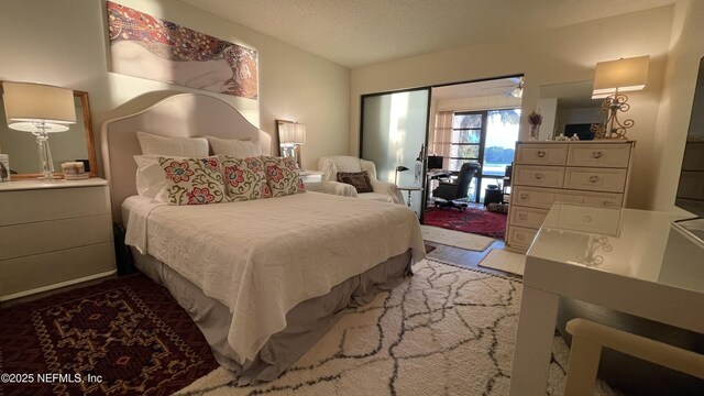2708 SW 14th Dr Unit 220, Gainesville, FL 32608 - bedroom featuring access to exterior and a textured ceiling