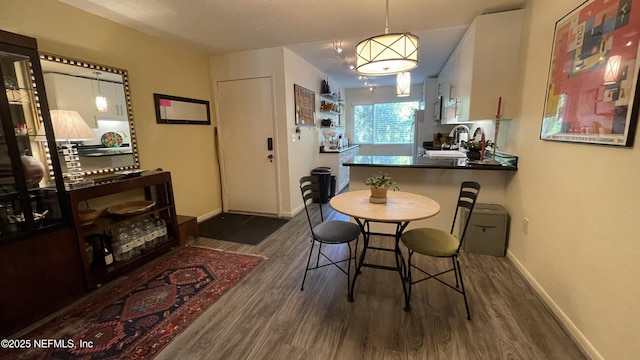 2708 SW 14th Dr Unit 220, Gainesville, FL 32608 - dining space with dark wood-style flooring