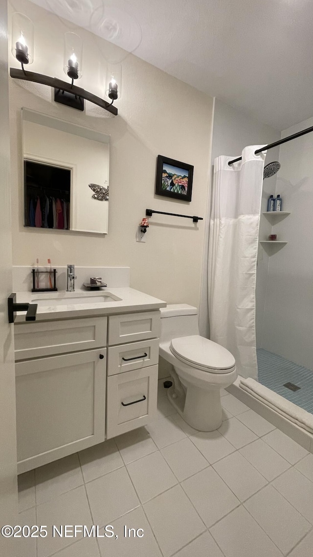 2708 SW 14th Dr Unit 220, Gainesville, FL 32608 - full bathroom featuring vanity, tile patterned flooring, and a stall shower
