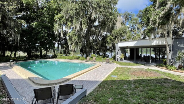 2708 SW 14th Dr Unit 220, Gainesville, FL 32608 - outdoor pool with a lawn and a patio area