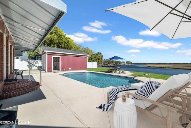 85712 Avant Rd, Yulee, FL 32097 - view of swimming pool featuring a patio, an outdoor structure, a water view, and an exterior structure