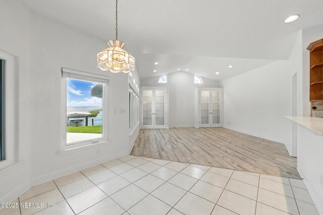 85712 Avant Rd, Yulee, FL 32097 - unfurnished dining area featuring vaulted ceiling, french doors, healthy amount of natural light, recessed lighting, and a chandelier