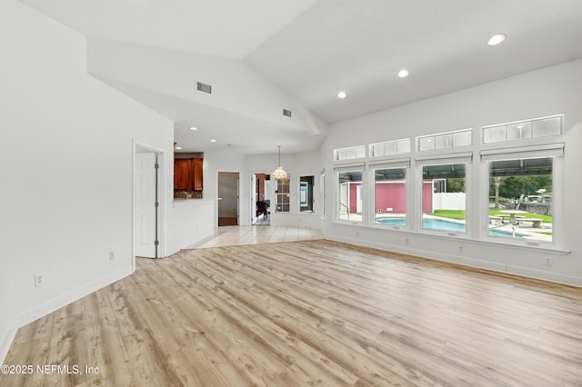 85712 Avant Rd, Yulee, FL 32097 - unfurnished living room featuring light wood-type flooring, recessed lighting, and high vaulted ceiling