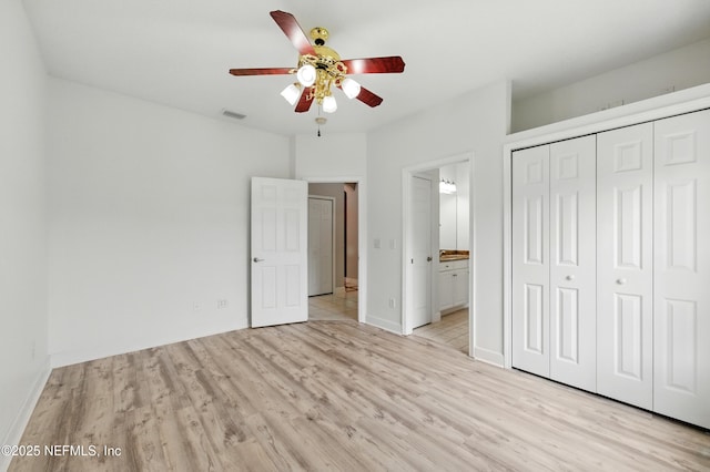85712 Avant Rd, Yulee, FL 32097 - unfurnished bedroom featuring light wood-style flooring, a closet, ensuite bathroom, and a ceiling fan