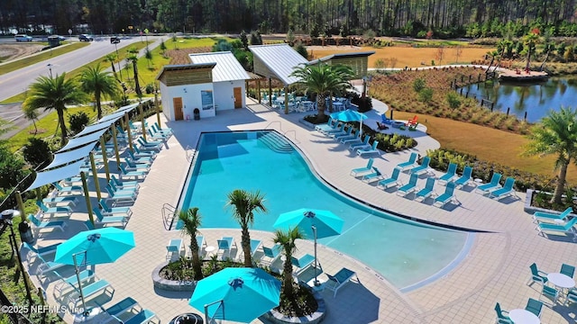 240 Julep St, Yulee, FL 32097 - community pool featuring a patio area and a wooded view