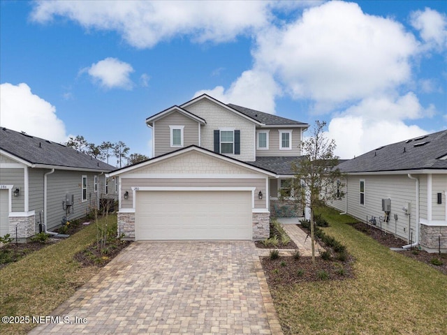 280 Cedar Elm Way, Saint Augustine, FL 32092 - craftsman-style home with decorative driveway, stone siding, a front yard, and an attached garage