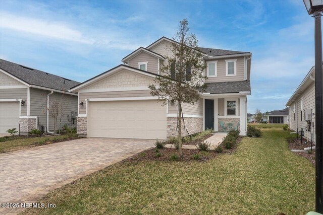 280 Cedar Elm Way, Saint Augustine, FL 32092 - craftsman house featuring a garage, driveway, a front yard, roof with shingles, and stone siding