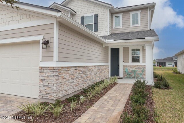 280 Cedar Elm Way, Saint Augustine, FL 32092 - view of front of home featuring a porch, stone siding, a garage, and roof with shingles