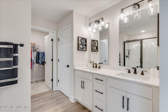 280 Cedar Elm Way, Saint Augustine, FL 32092 - full bathroom with wood finished floors, a stall shower, double vanity, and a spacious closet