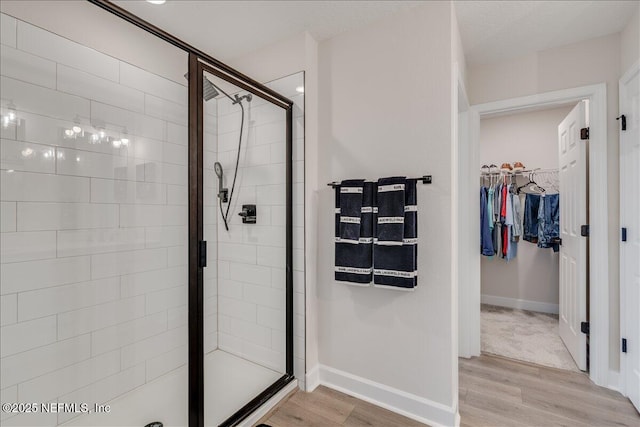 280 Cedar Elm Way, Saint Augustine, FL 32092 - full bathroom featuring a shower stall, a spacious closet, and wood finished floors