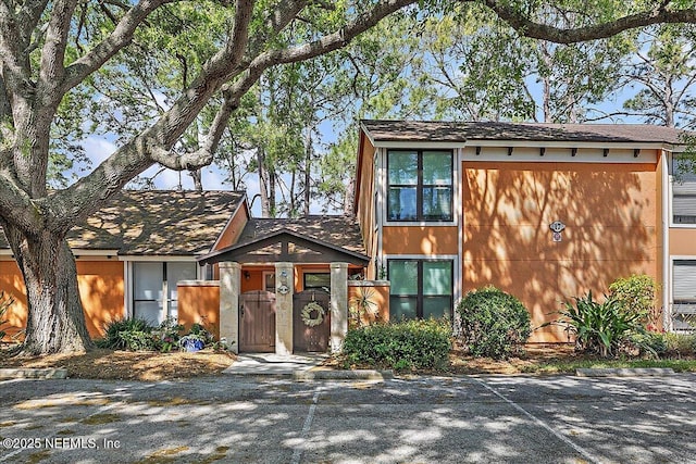 822 Coquina Bay, Ponte Vedra Beach, FL 32082 - view of front of house featuring stucco siding and a gate