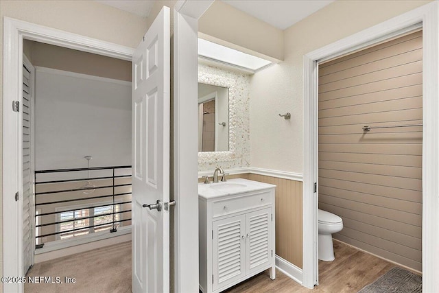 822 Coquina Bay, Ponte Vedra Beach, FL 32082 - bathroom with vanity, wainscoting, wood finished floors, and wood walls