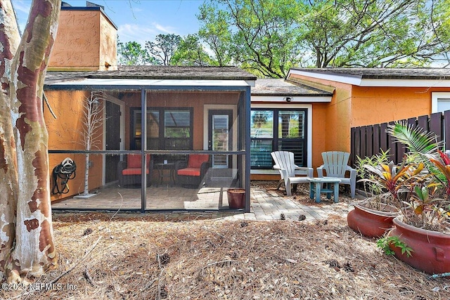 822 Coquina Bay, Ponte Vedra Beach, FL 32082 - back of property featuring a sunroom, a patio area, a chimney, and stucco siding