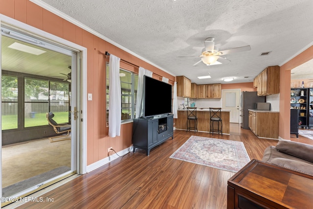 270 Drew St W, Baldwin, FL 32234 - living area with a ceiling fan, ornamental molding, dark wood-style floors, and a textured ceiling