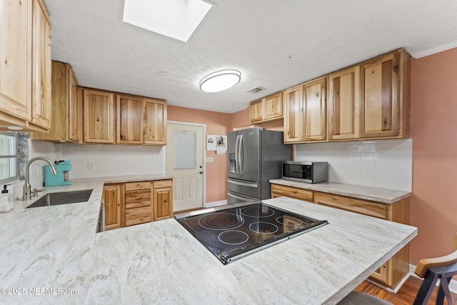 270 Drew St W, Baldwin, FL 32234 - kitchen with appliances with stainless steel finishes, a skylight, backsplash, a peninsula, and a textured ceiling