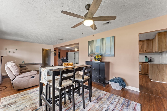 270 Drew St W, Baldwin, FL 32234 - dining space with a ceiling fan, a textured ceiling, and dark wood-style floors