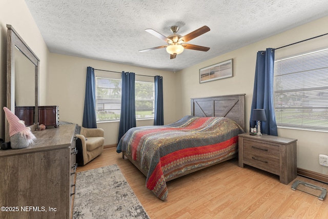 270 Drew St W, Baldwin, FL 32234 - bedroom with light wood-style flooring, a textured ceiling, and ceiling fan