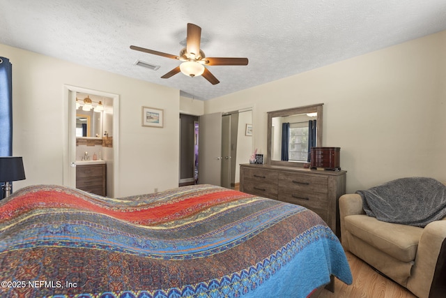 270 Drew St W, Baldwin, FL 32234 - bedroom featuring wood finished floors, a textured ceiling, ensuite bathroom, a ceiling fan, and a closet