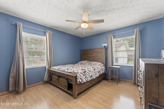 270 Drew St W, Baldwin, FL 32234 - bedroom with light wood-style flooring, a textured ceiling, and a ceiling fan