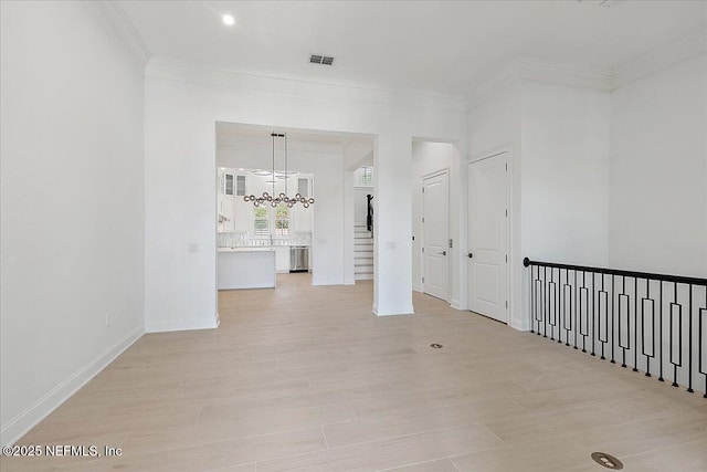13892 Atlantic Blvd, Jacksonville, FL 32225 - unfurnished room with a chandelier, crown molding, and light wood-type flooring