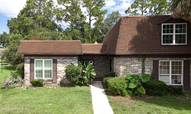 9252 San Jose Blvd Unit 2704, Jacksonville, FL 32257 - view of front property with a shingled roof, mansard roof, a front yard, and brick siding