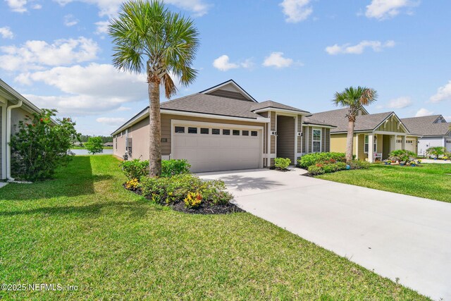 100 Dove Tree Ln, Saint Augustine, FL 32095 - single story home featuring a garage, concrete driveway, a front lawn, and a shingled roof