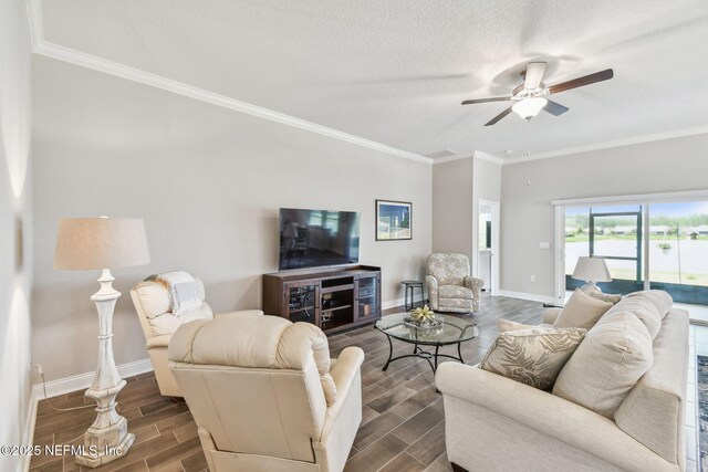 100 Dove Tree Ln, Saint Augustine, FL 32095 - living room with wood tiled floors, crown molding, ceiling fan, and a textured ceiling
