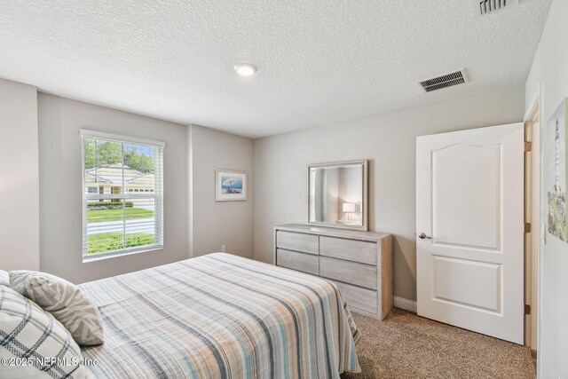 100 Dove Tree Ln, Saint Augustine, FL 32095 - bedroom featuring light carpet and a textured ceiling